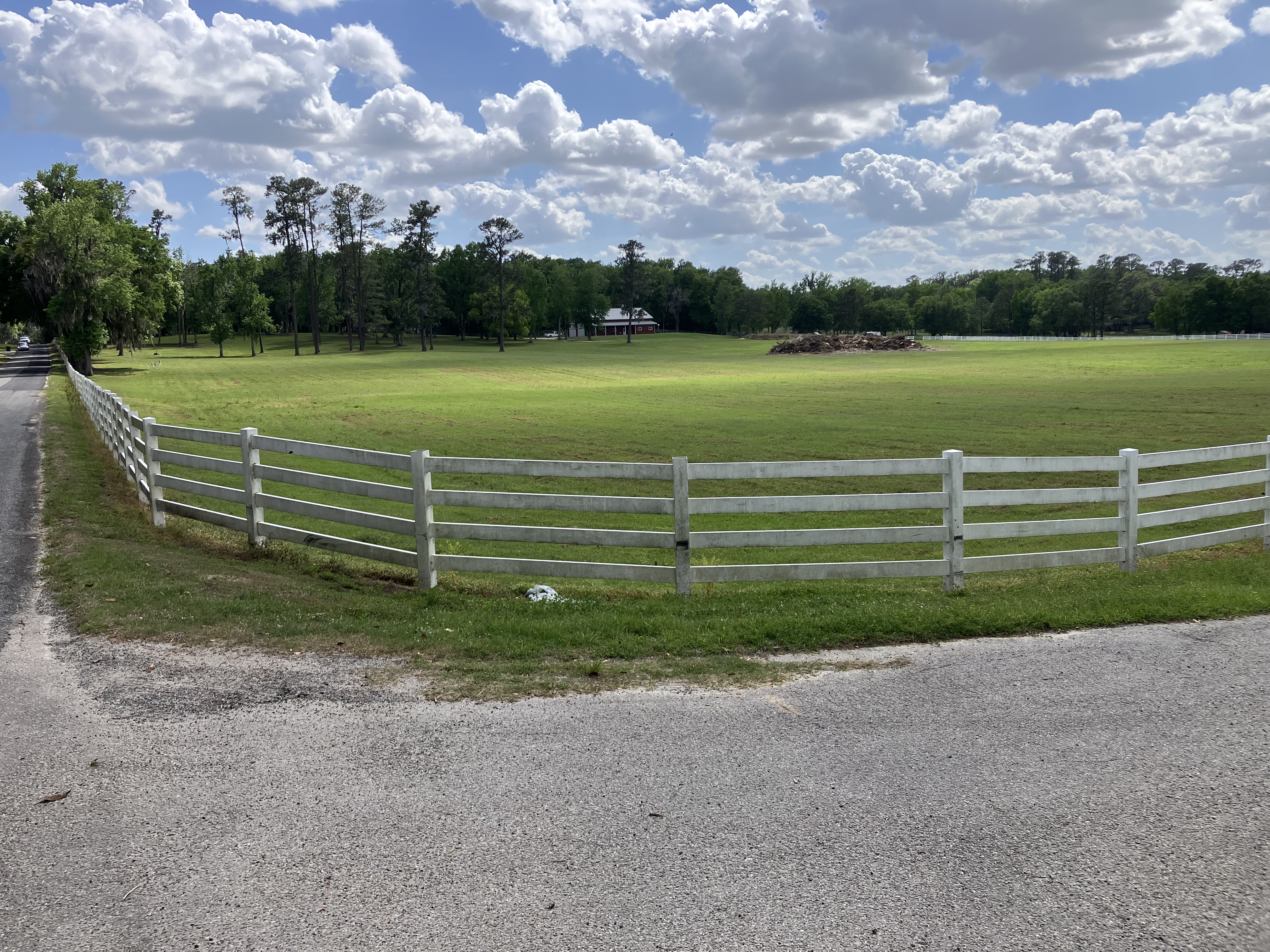 White vinyl perimeter fence on horse property